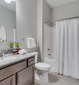 a young man smiling while sitting on the couch holding his coffee